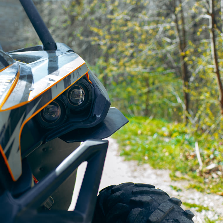 Close-up of an off-road buggy's headlights and roll cage