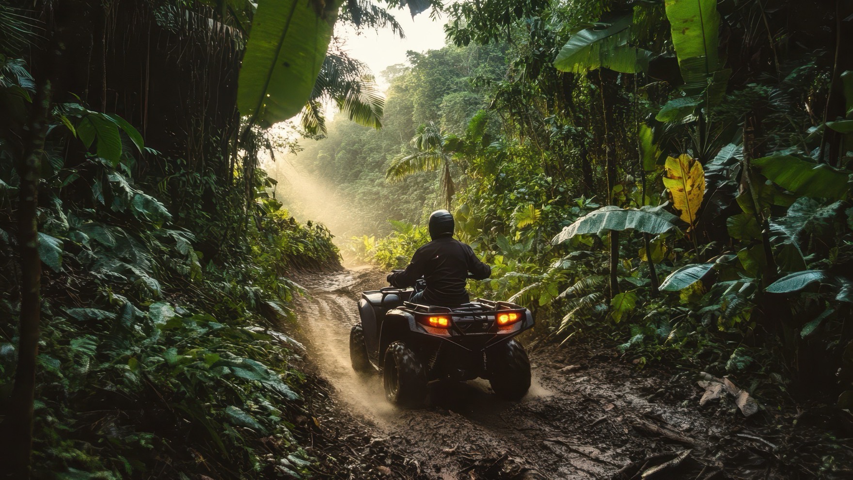 ATV rider working through a deeply rutted muddy path in dense jungle on the experienced trail